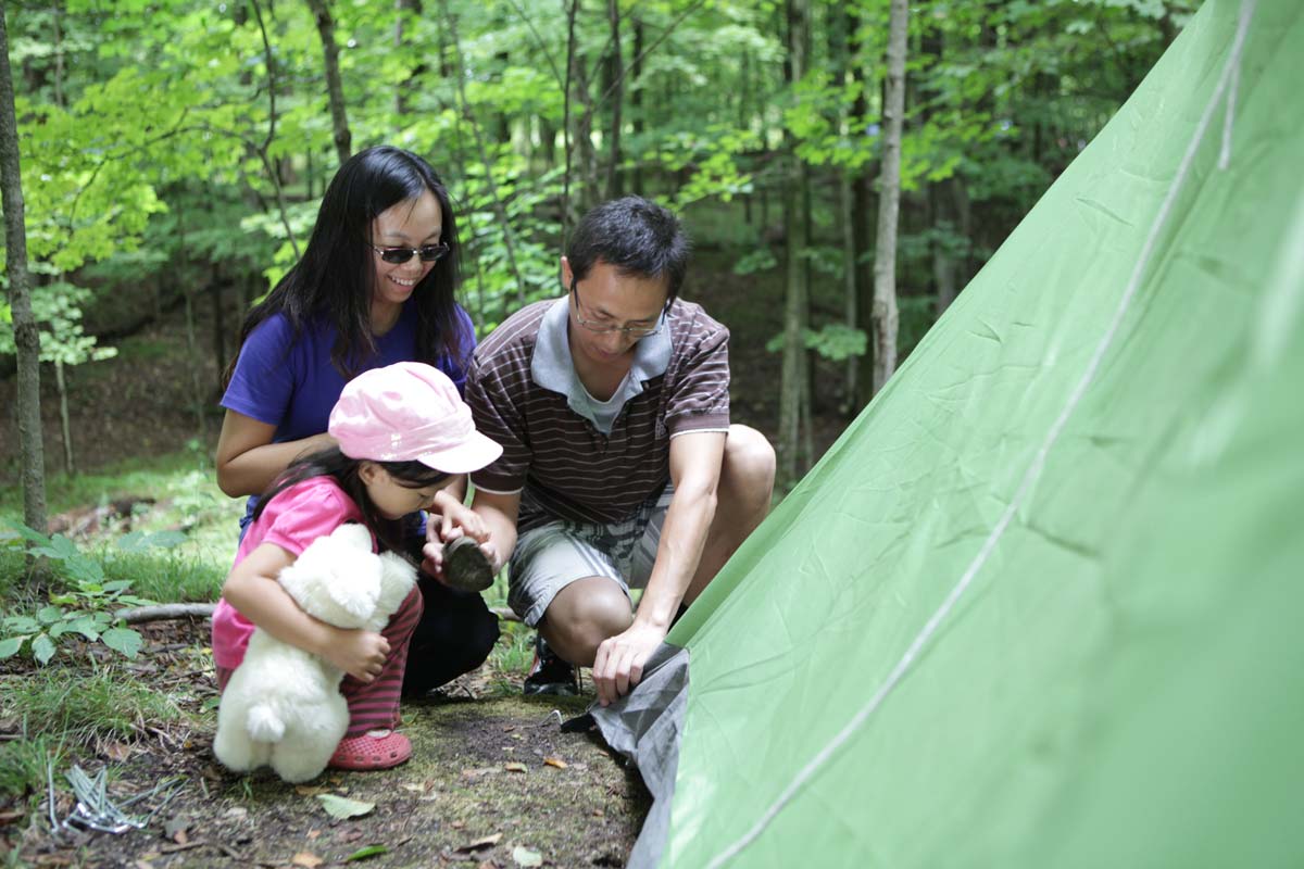 Family setting up tent