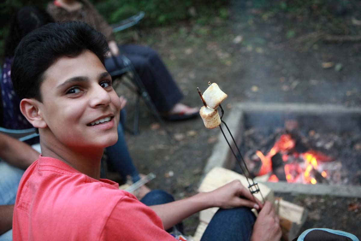 Roasting marshmallows over campfire