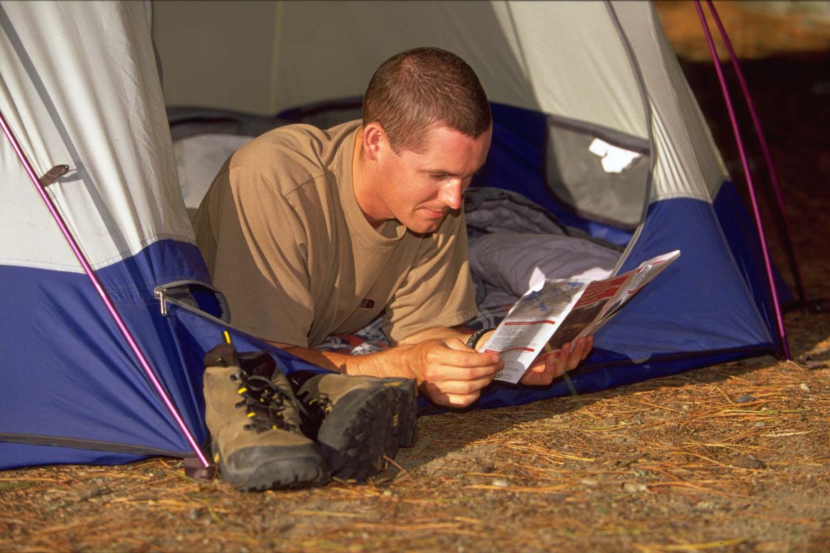 Reading a book in a tent