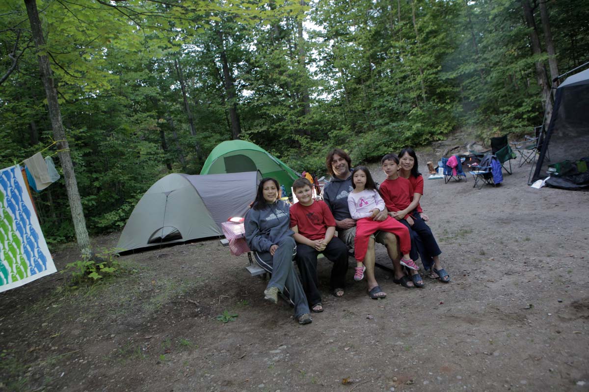 Family sitting at campsite