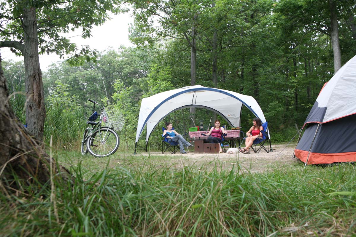 Campers sitting under a picnic shelter